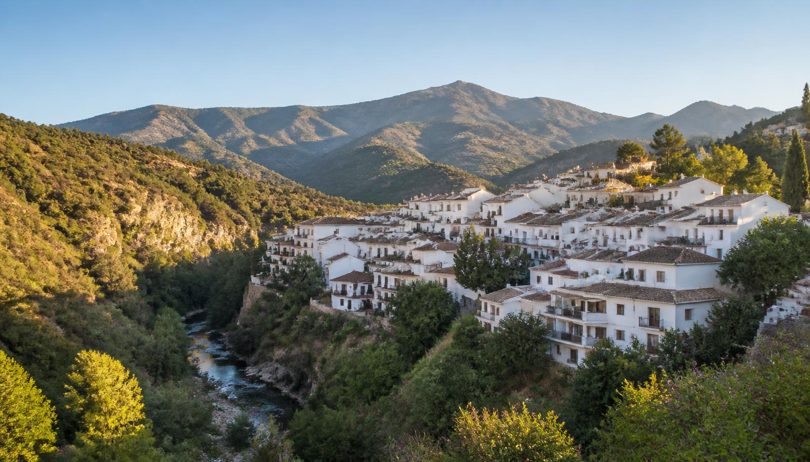 Whitewashed houses of Benahavís village above the river valley in Málaga province, Spain