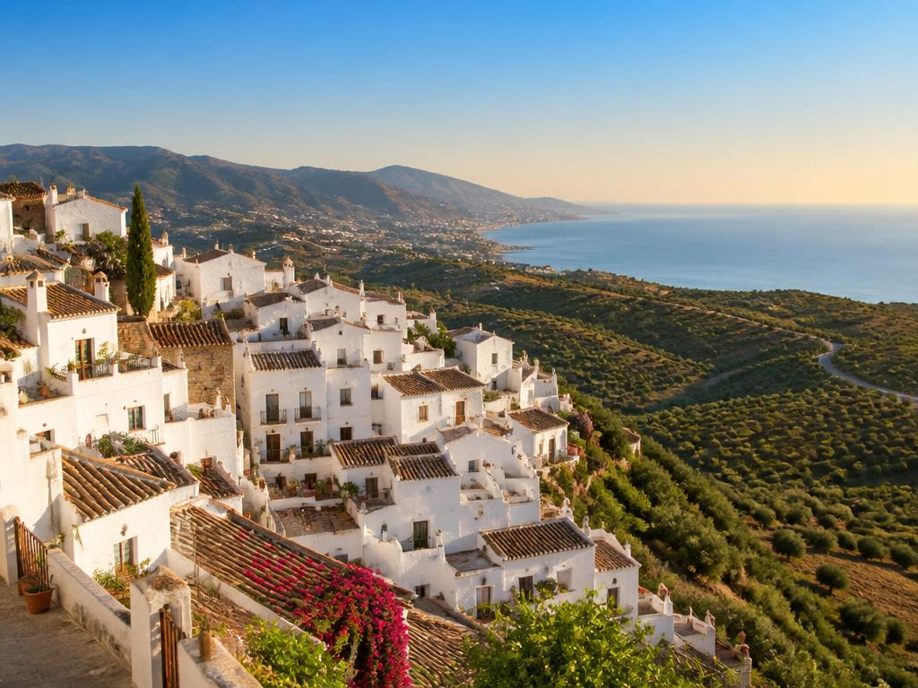 Whitewashed Spanish village and coastline representing nationwide holiday rental licence coverage